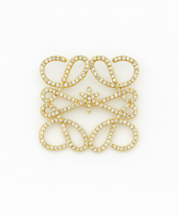 Goudkleurige broche met steentjes